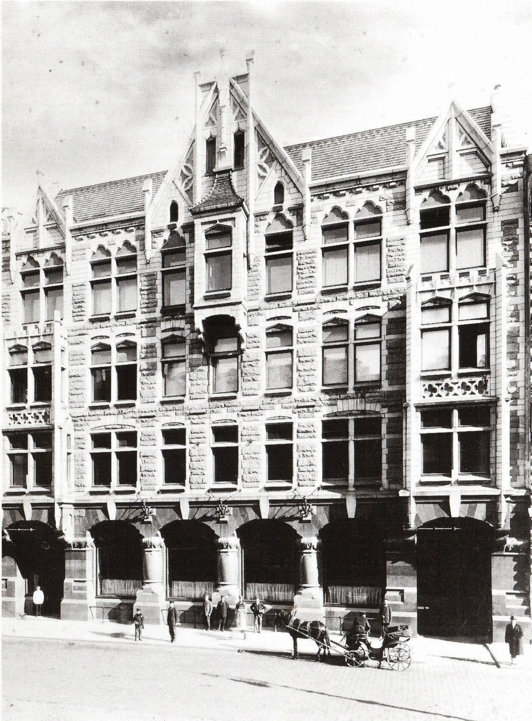Vintage black and white photograph of a tall building with decorative architecture.