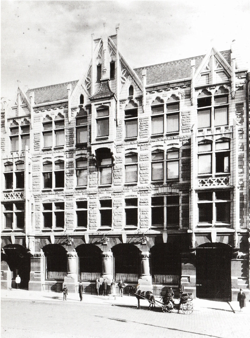 Vintage black and white photograph of a tall building with decorative architecture.
